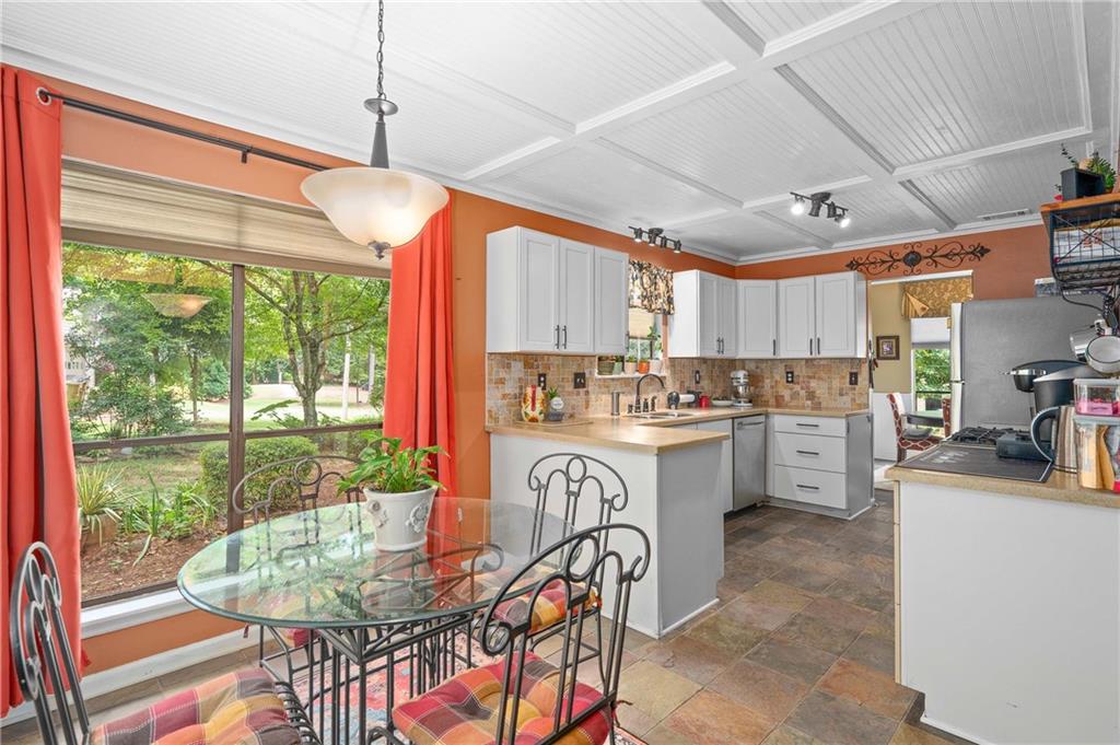 1528 Forest Trace Marietta, GA 30066 - Photo 9 of 26 a kitchen with a table chairs stove and cabinets