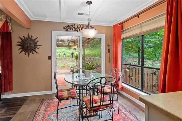 a dining room with furniture window and outside view
