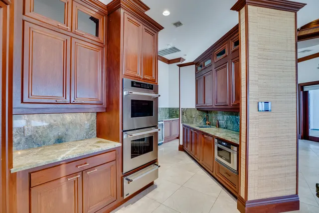 a kitchen with stainless steel appliances granite countertop a stove and a refrigerator