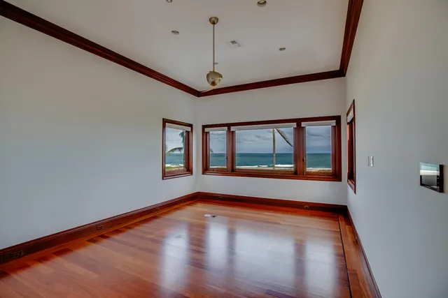 a view of an empty room with window and fire place