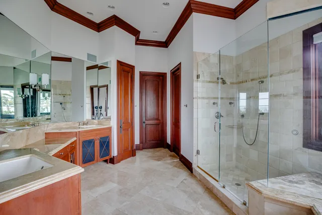 a spacious bathroom with a tub double sink and a mirror
