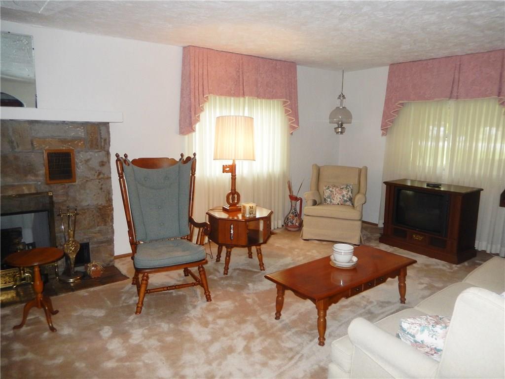 266 Buckeye Road Mount Pleasant, PA 15666 - Photo 3 of 19 Living room with stone fireplace for relaxing with family and friends