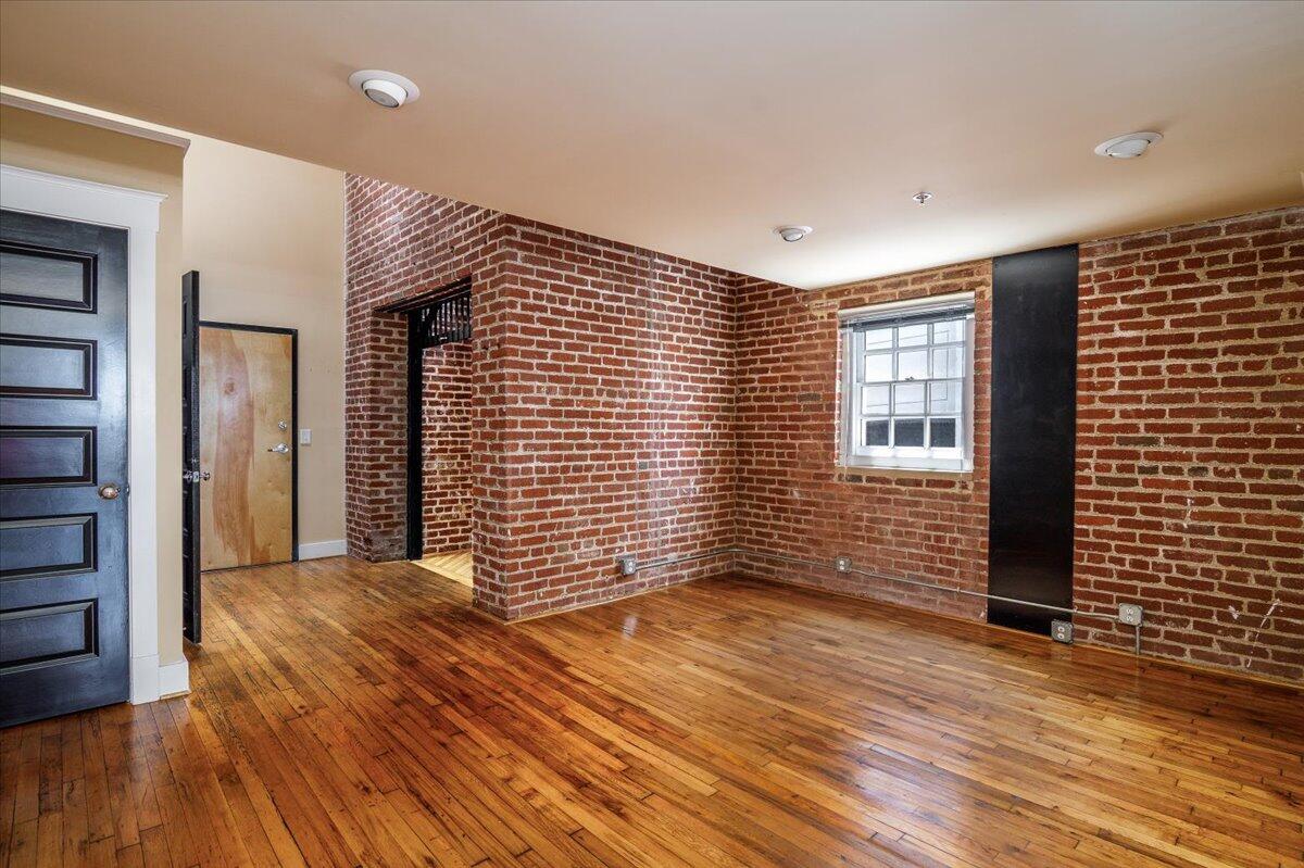 324 Salem Avenue Southwest, Unit 303 Roanoke, VA 24016 - Photo 14 of 21 an empty room with wooden floor and windows