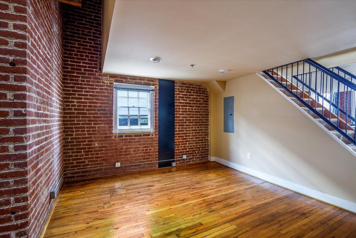 324 Salem Avenue Southwest, Unit 303 Roanoke, VA 24016 - Photo 15 of 21 a view of an empty room with wooden floor and a window