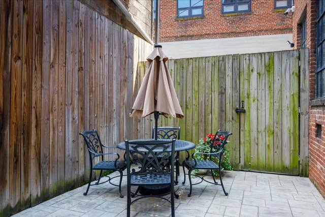 a view of outdoor dining space with a table and chairs