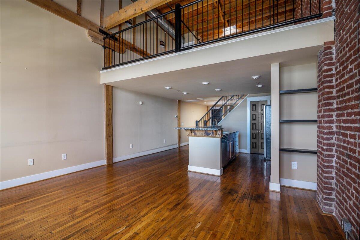 324 Salem Avenue Southwest, Unit 303 Roanoke, VA 24016 - Photo 5 of 21 a view of a hallway with wooden floor and staircase