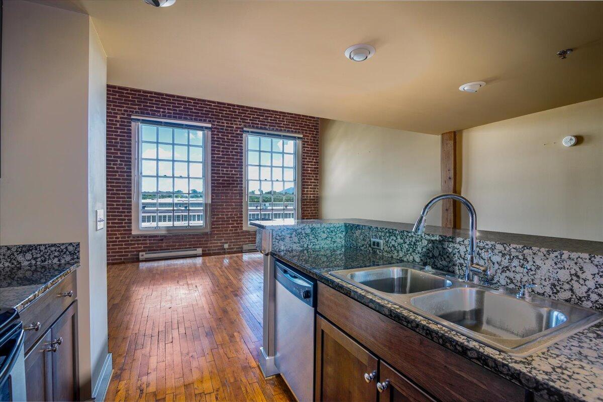 324 Salem Avenue Southwest, Unit 303 Roanoke, VA 24016 - Photo 10 of 21 a kitchen with granite countertop a sink and a stove