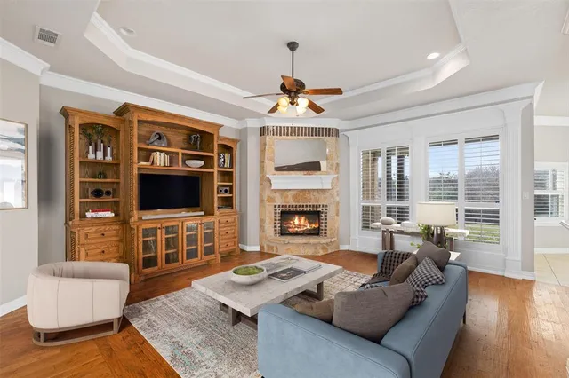 an empty room with windows fireplace and cabinet