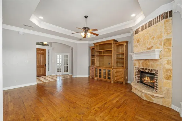 a view of an empty room with a fireplace and a window