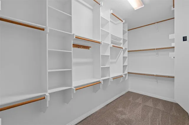 a bathroom with a granite countertop sink a mirror and a toilet