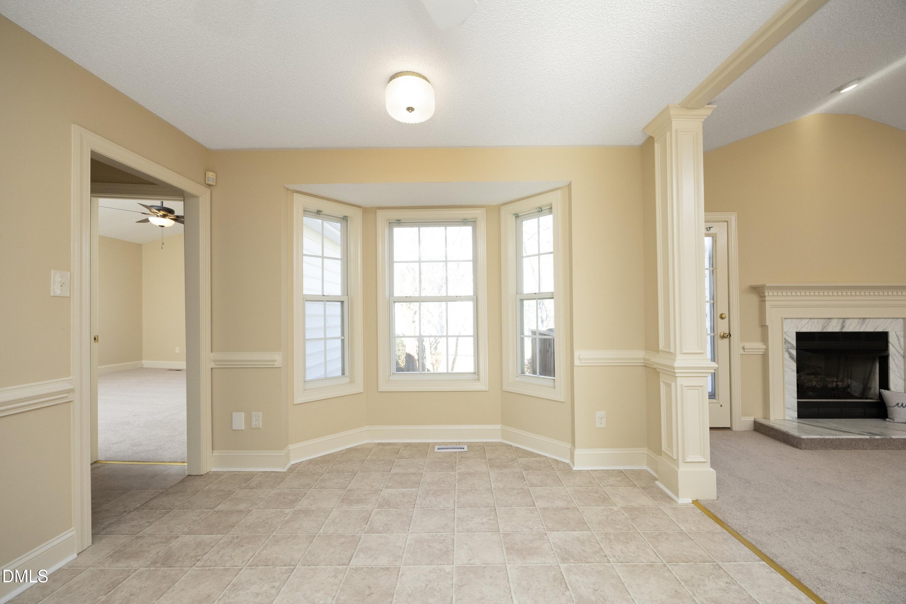 103 Brims Way Garner, NC 27529 - Photo 16 of 36 a view of an empty room with a fireplace and a window