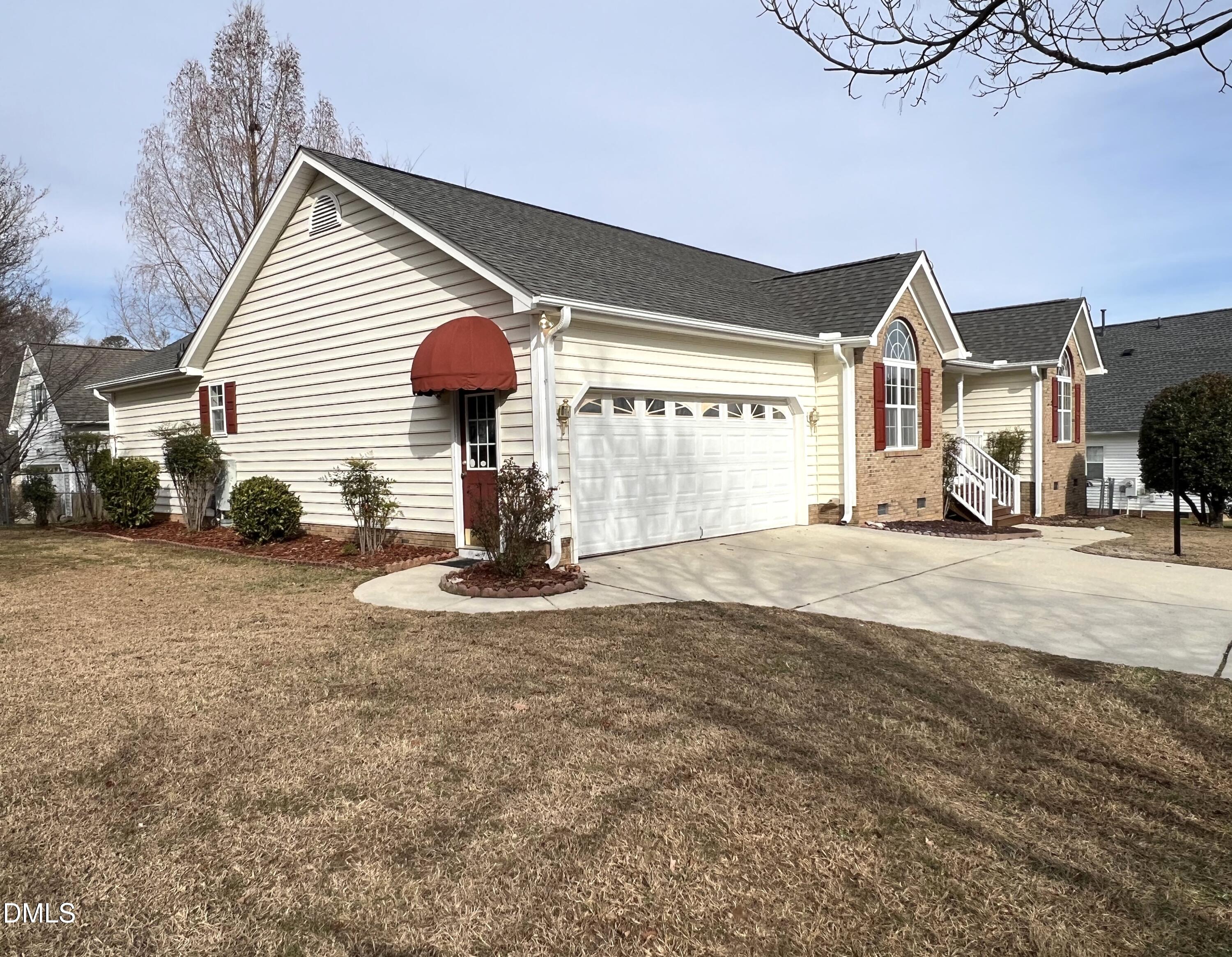103 Brims Way Garner, NC 27529 - Photo 2 of 36 a front view of a house with a yard and garage