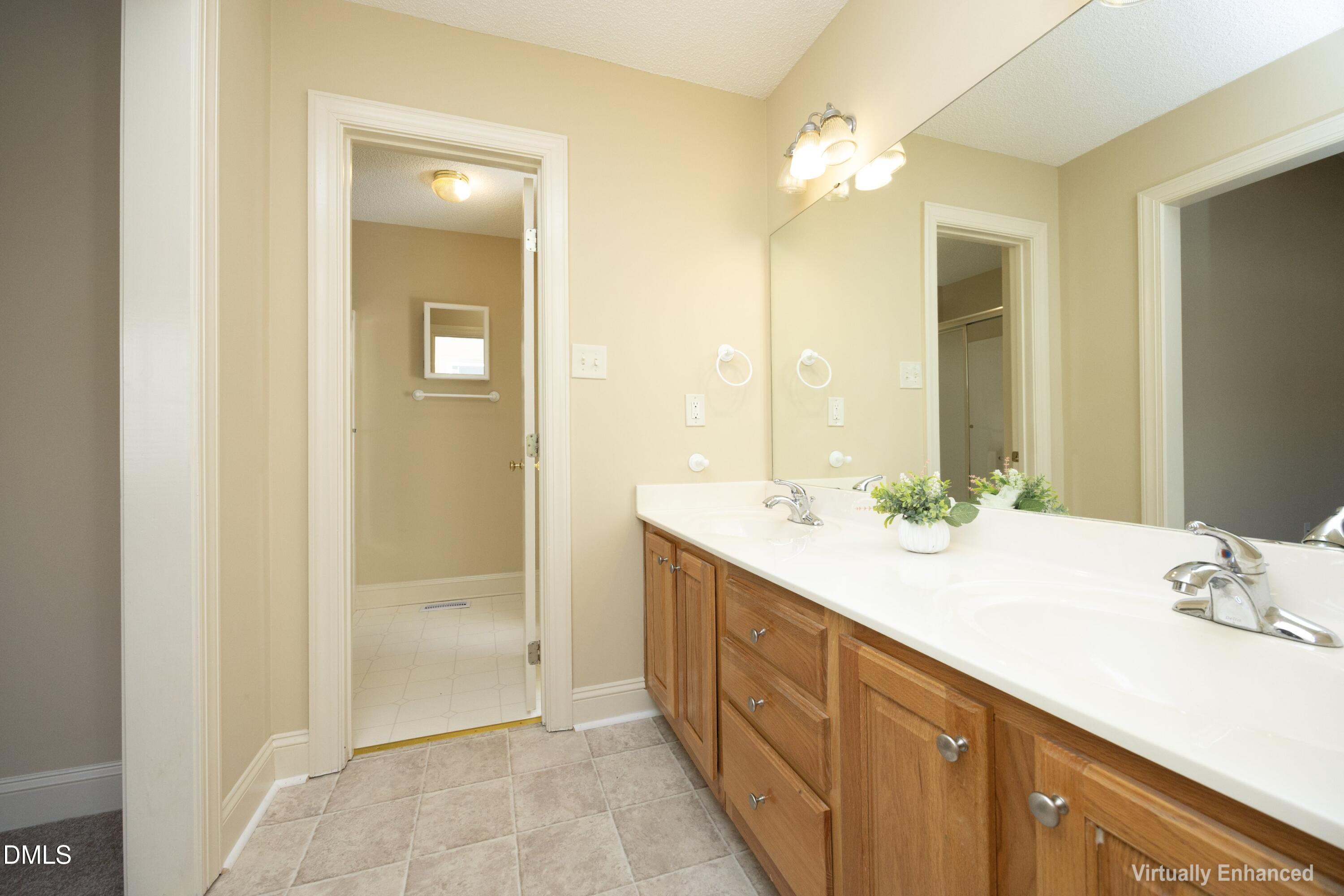 103 Brims Way Garner, NC 27529 - Photo 23 of 36 a bathroom with a double vanity sink mirror and next to a window