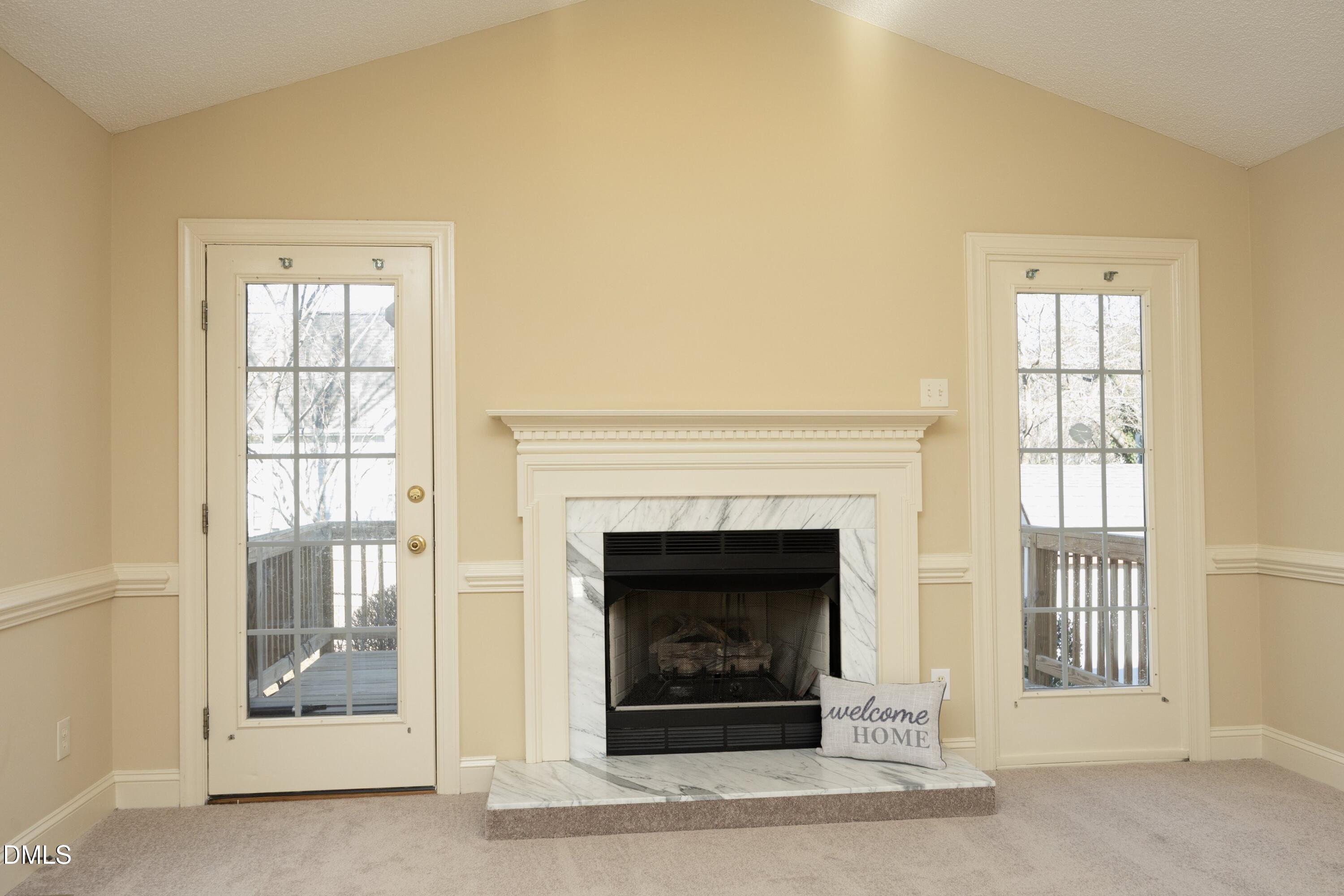 103 Brims Way Garner, NC 27529 - Photo 9 of 36 a living room with a fireplace and a window