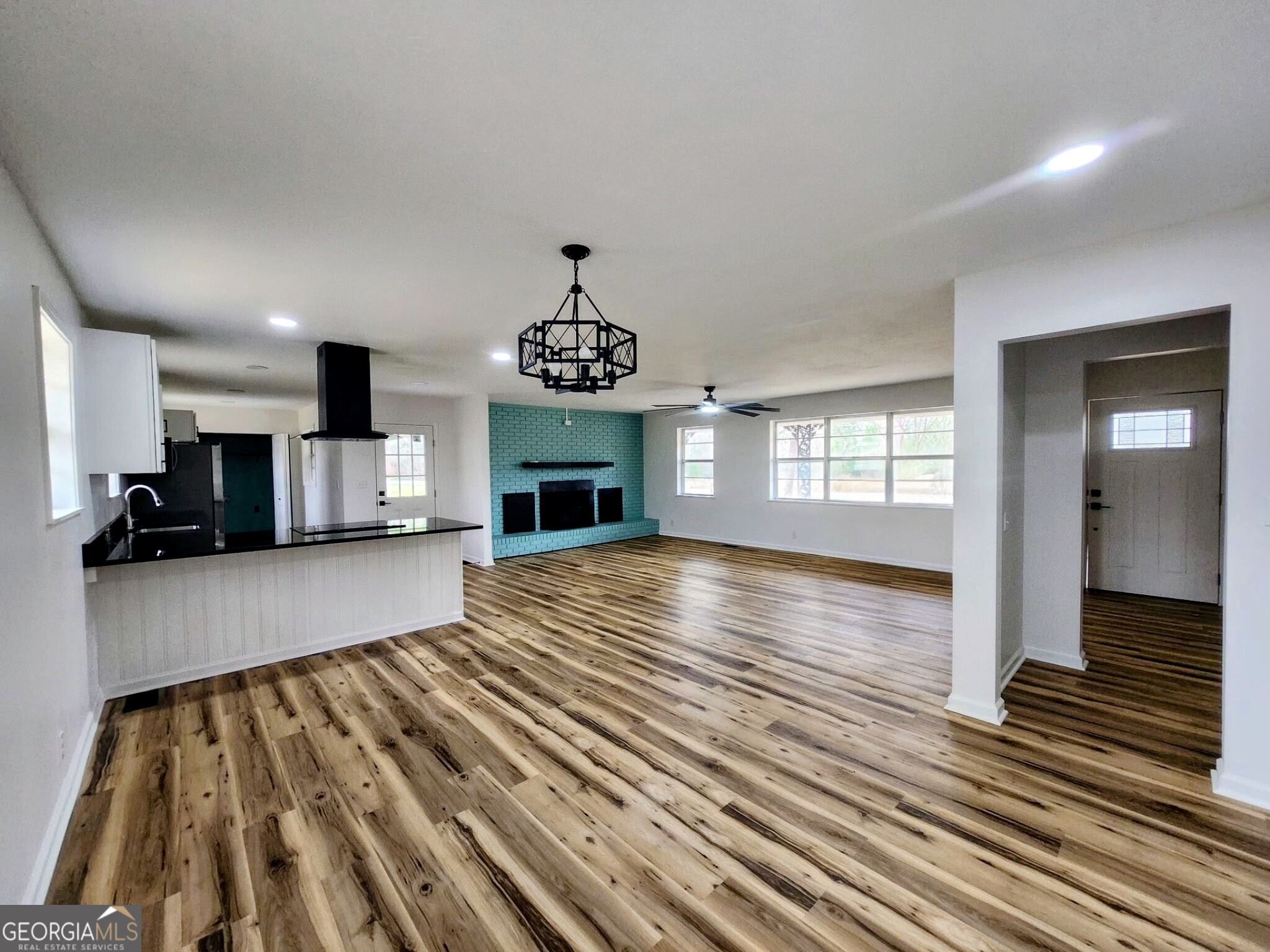 267 Evergreen Road Fitzgerald, GA 31750 - Photo 12 of 22 a view of an empty room and kitchen with wooden floor