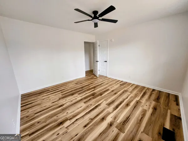 a view of a room with a ceiling fan