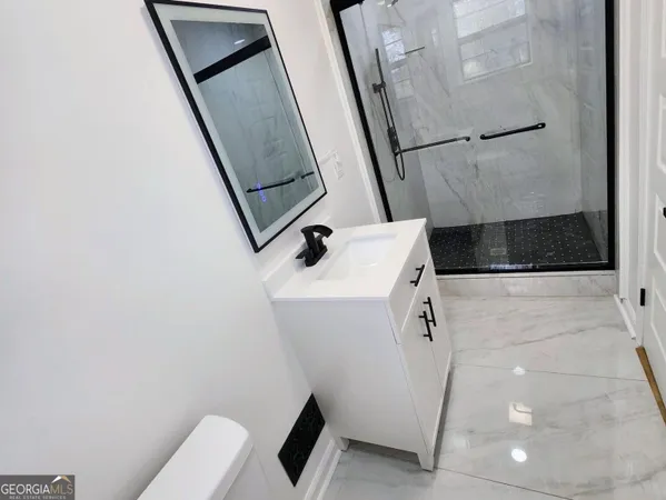 a bathroom with a sink a toilet a mirror and vanity