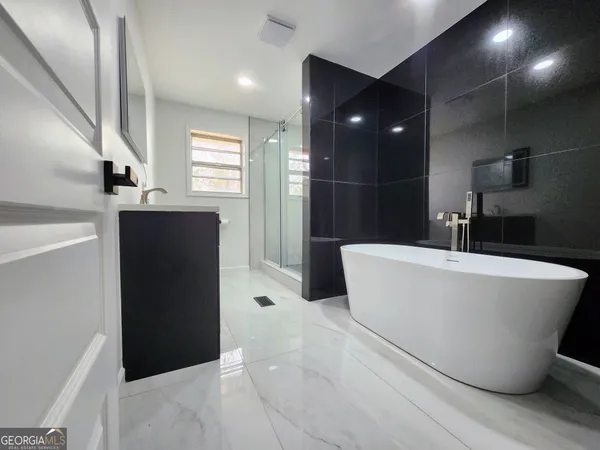 a bathroom with a bathtub and shower
