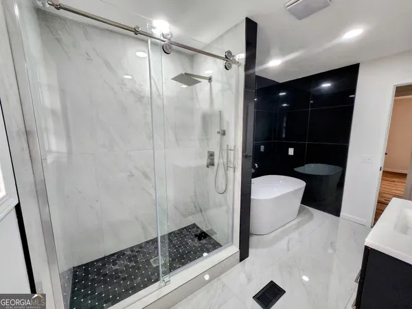 a bathroom with a shower and a sink