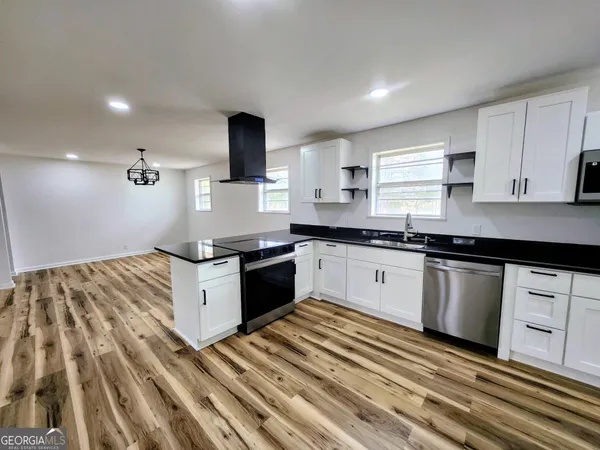 a kitchen with granite countertop stainless steel appliances and sink