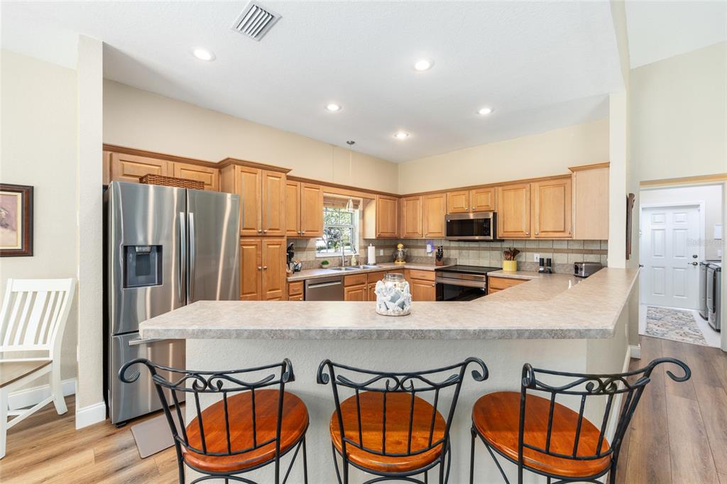 19639 Southwest 77th Loop Dunnellon, FL 34432 - Photo 27 of 59 a kitchen with stainless steel appliances granite countertop a kitchen island a table and chairs