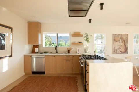 a kitchen with a sink stove and cabinets