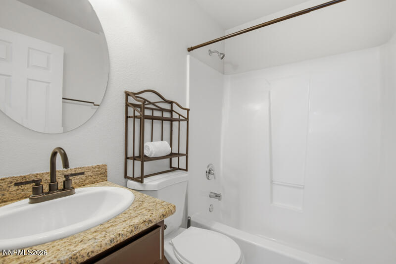 1367 Calavaras Road Reno, NV 89521 - Photo 19 of 26 a bathroom with a granite countertop sink toilet and shower