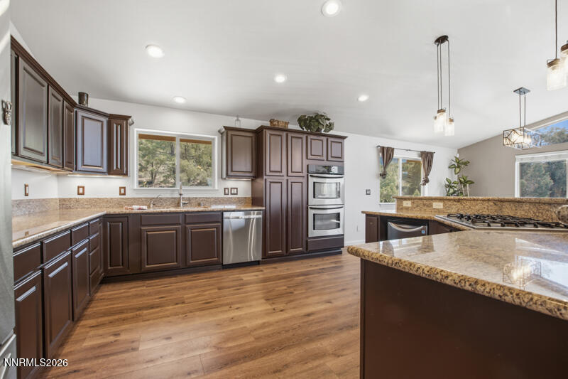 1367 Calavaras Road Reno, NV 89521 - Photo 5 of 26 a kitchen with stainless steel appliances granite countertop a refrigerator a sink dishwasher a oven and a oven with wooden floor