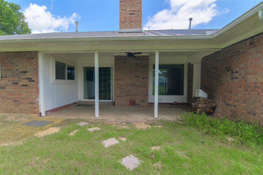 301 East 6th Street Krum, TX 76249 - Photo 28 of 29 Large, covered patio with sliding door that enters into living area.