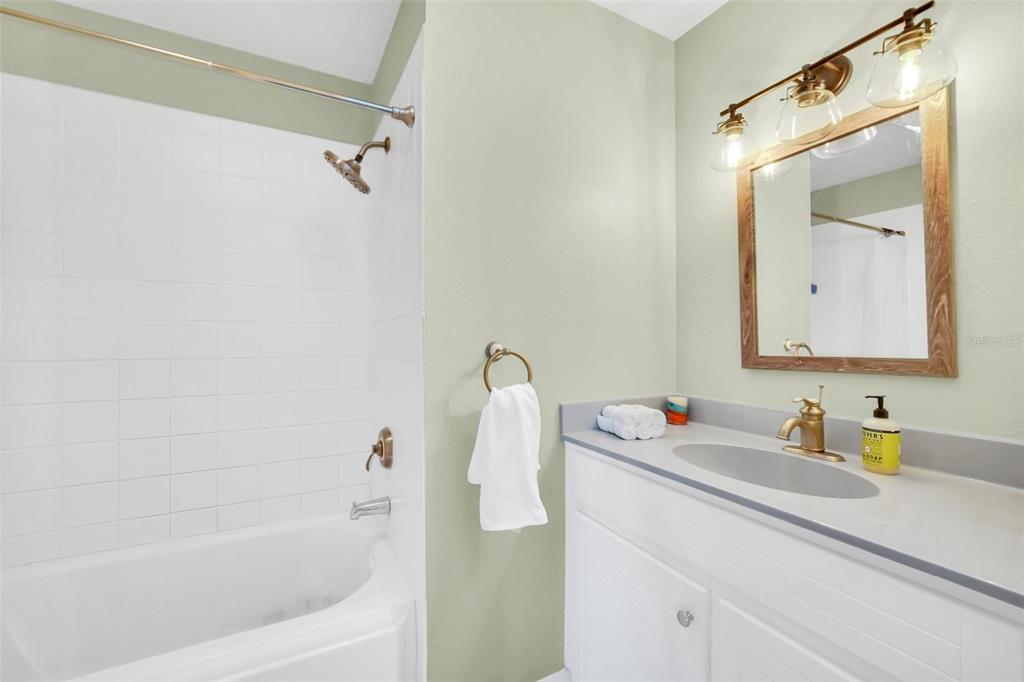 5 Southeast Ocale Way Summerfield, FL 34491 - Photo 11 of 18 a bathroom with a tub sink and mirror
