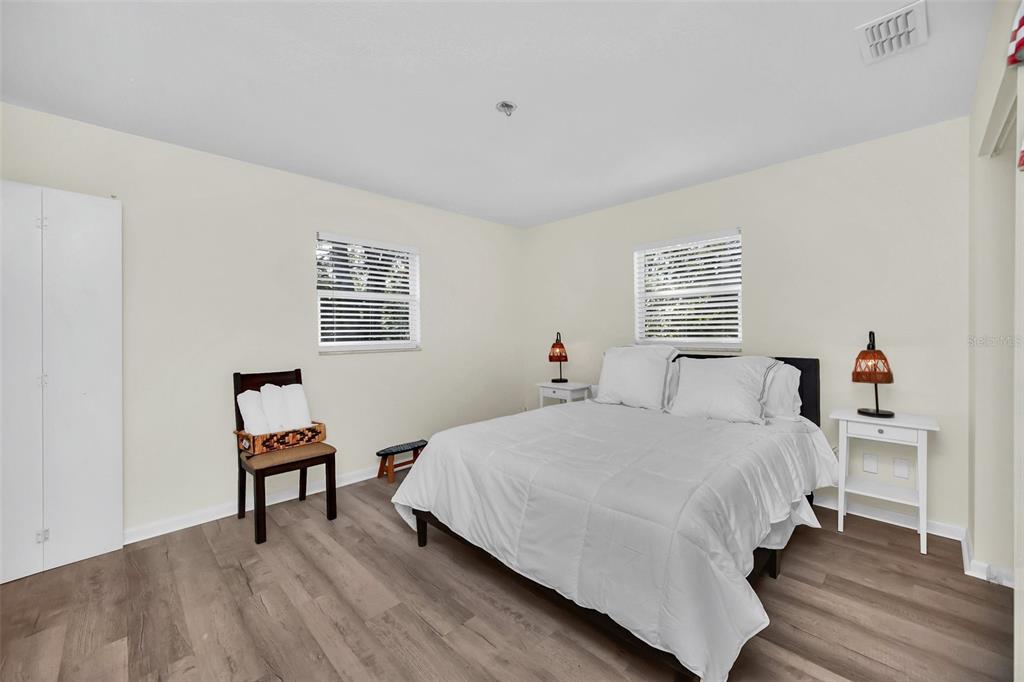 5 Southeast Ocale Way Summerfield, FL 34491 - Photo 12 of 18 a bedroom with a bed and a chair