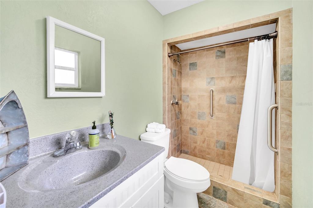 5 Southeast Ocale Way Summerfield, FL 34491 - Photo 13 of 18 a bathroom with a granite countertop sink toilet and shower