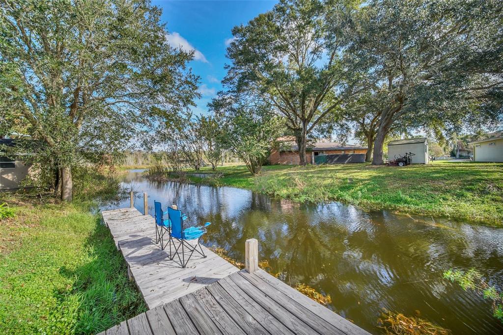 5 Southeast Ocale Way Summerfield, FL 34491 - Photo 17 of 18 a view of a lake with a bench and trees