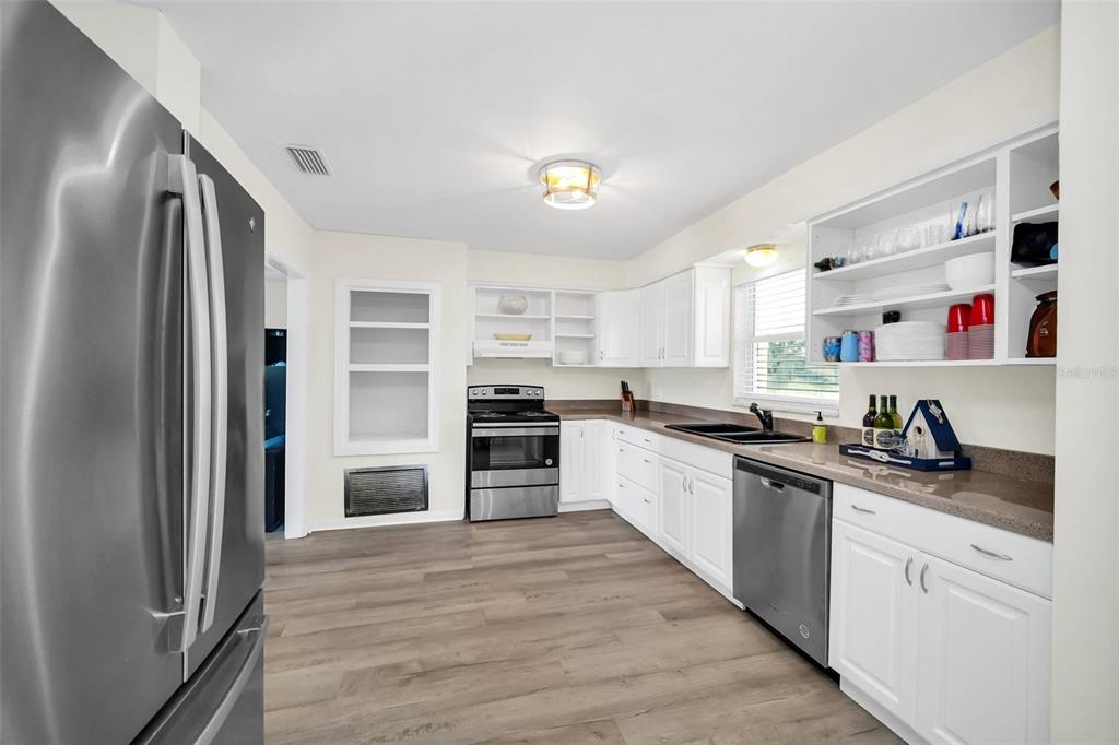5 Southeast Ocale Way Summerfield, FL 34491 - Photo 5 of 18 a kitchen with granite countertop a refrigerator oven a sink and dishwasher