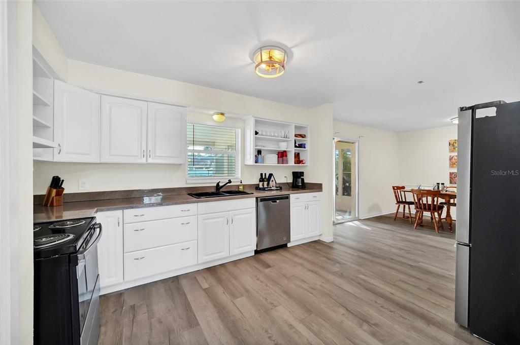 5 Southeast Ocale Way Summerfield, FL 34491 - Photo 6 of 18 a kitchen with a sink cabinets and wooden floor