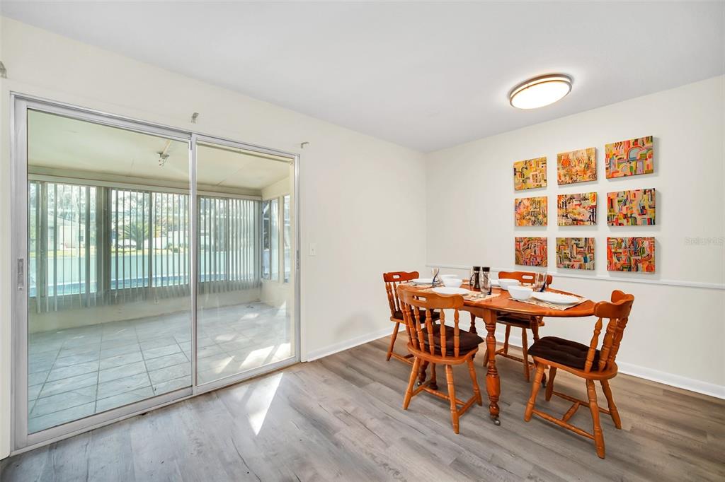 5 Southeast Ocale Way Summerfield, FL 34491 - Photo 7 of 18 a view of a dining room with furniture and wooden floor