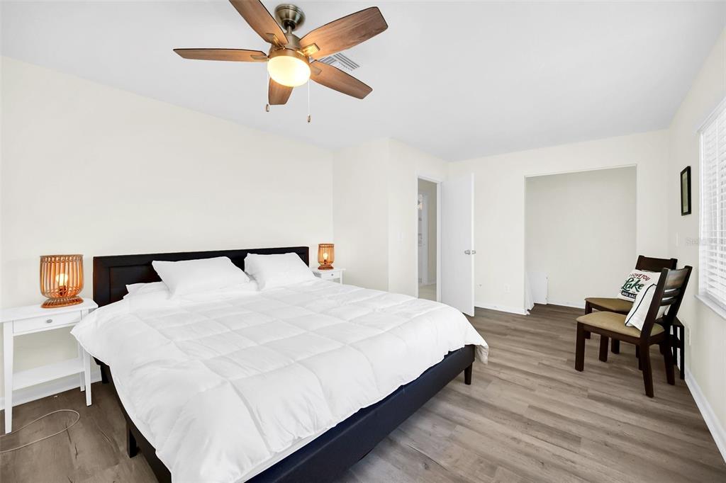 5 Southeast Ocale Way Summerfield, FL 34491 - Photo 10 of 18 a bedroom with a bed and a chandelier
