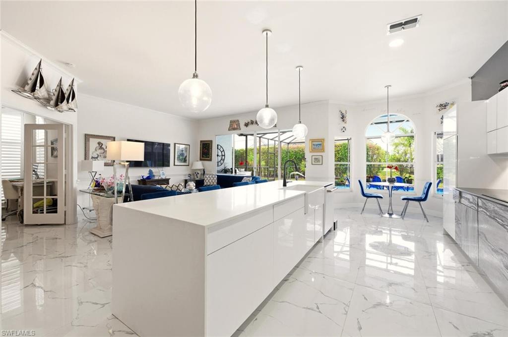209 Countryside Drive Naples, FL 34104 - Photo 49 of 50 Kitchen featuring modern cabinets, white cabinets, open floor plan, and pendant lighting