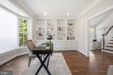 a kitchen with stainless steel appliances granite countertop a stove a refrigerator a kitchen island a stove and a wooden floors