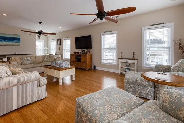 a living room with furniture window and wooden floor