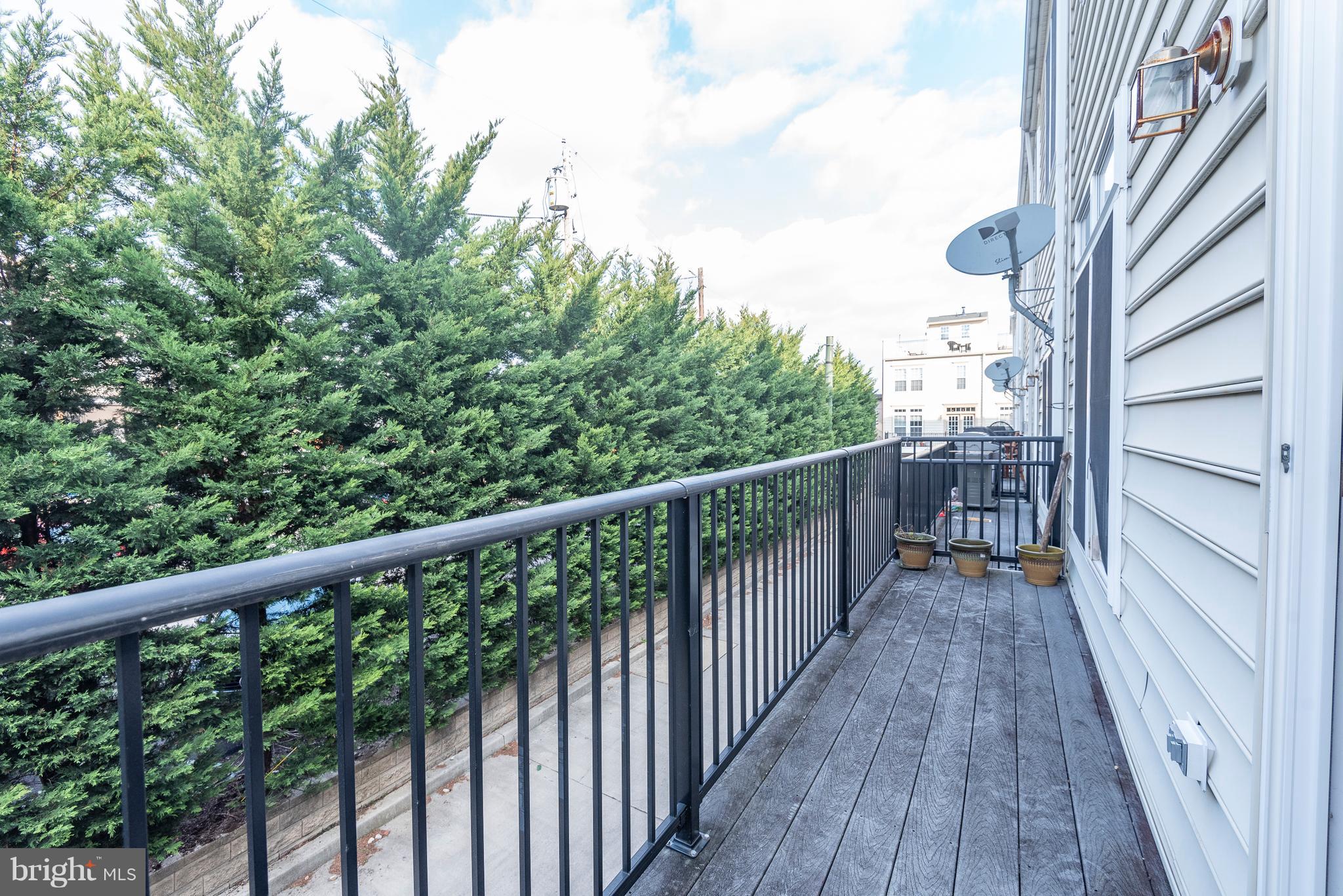 1510 Stack Street Baltimore, MD 21230 - Photo 11 of 32 a view of balcony with wooden floor and fence