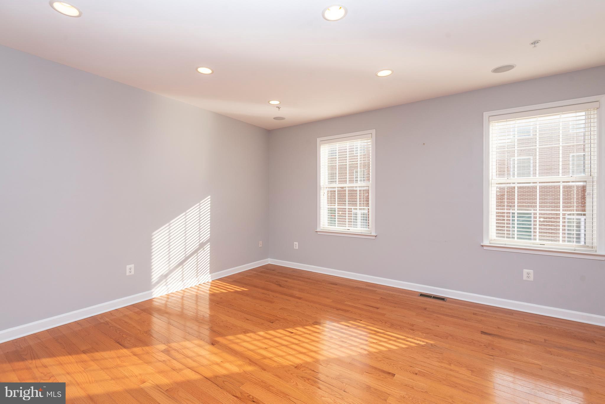 1510 Stack Street Baltimore, MD 21230 - Photo 13 of 32 an empty room with wooden floor and windows