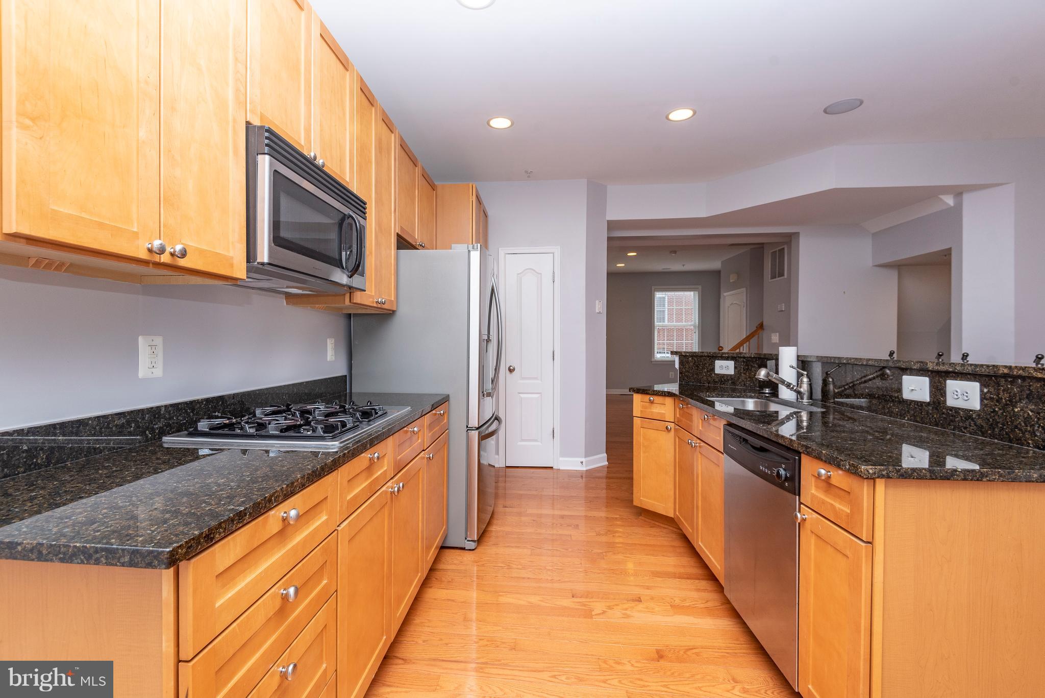 1510 Stack Street Baltimore, MD 21230 - Photo 8 of 32 a large kitchen with stainless steel appliances granite countertop a stove and a sink