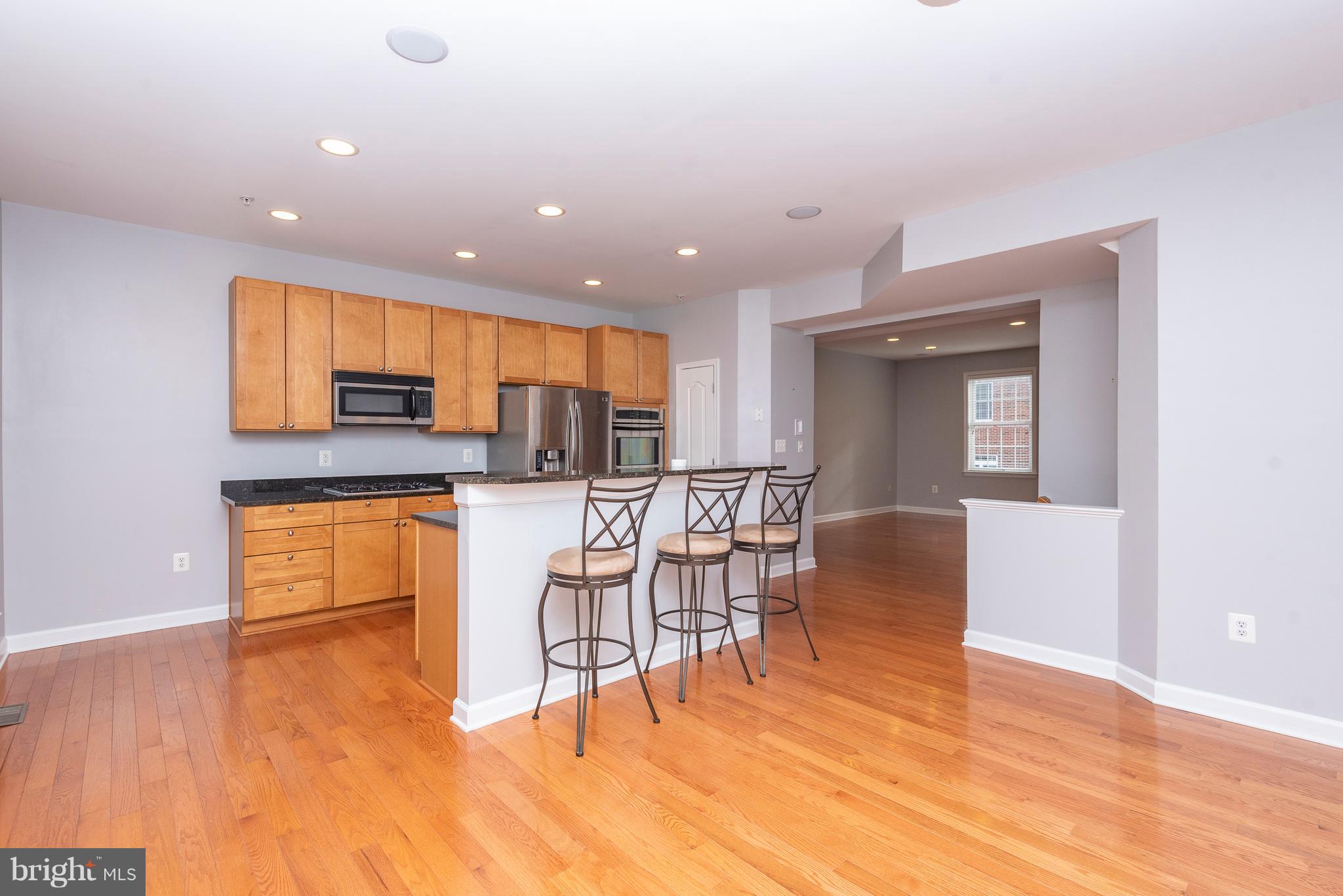 1510 Stack Street Baltimore, MD 21230 - Photo 9 of 32 a kitchen with stainless steel appliances a dining table chairs and granite counter tops