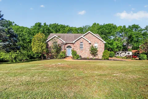 a view of a house with a yard and garage
