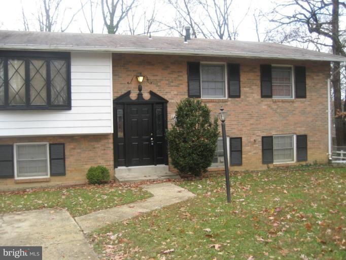 8606 Riggs Road Hyattsville, MD 20783 - Photo 1 of 3 a front view of a house with a garden