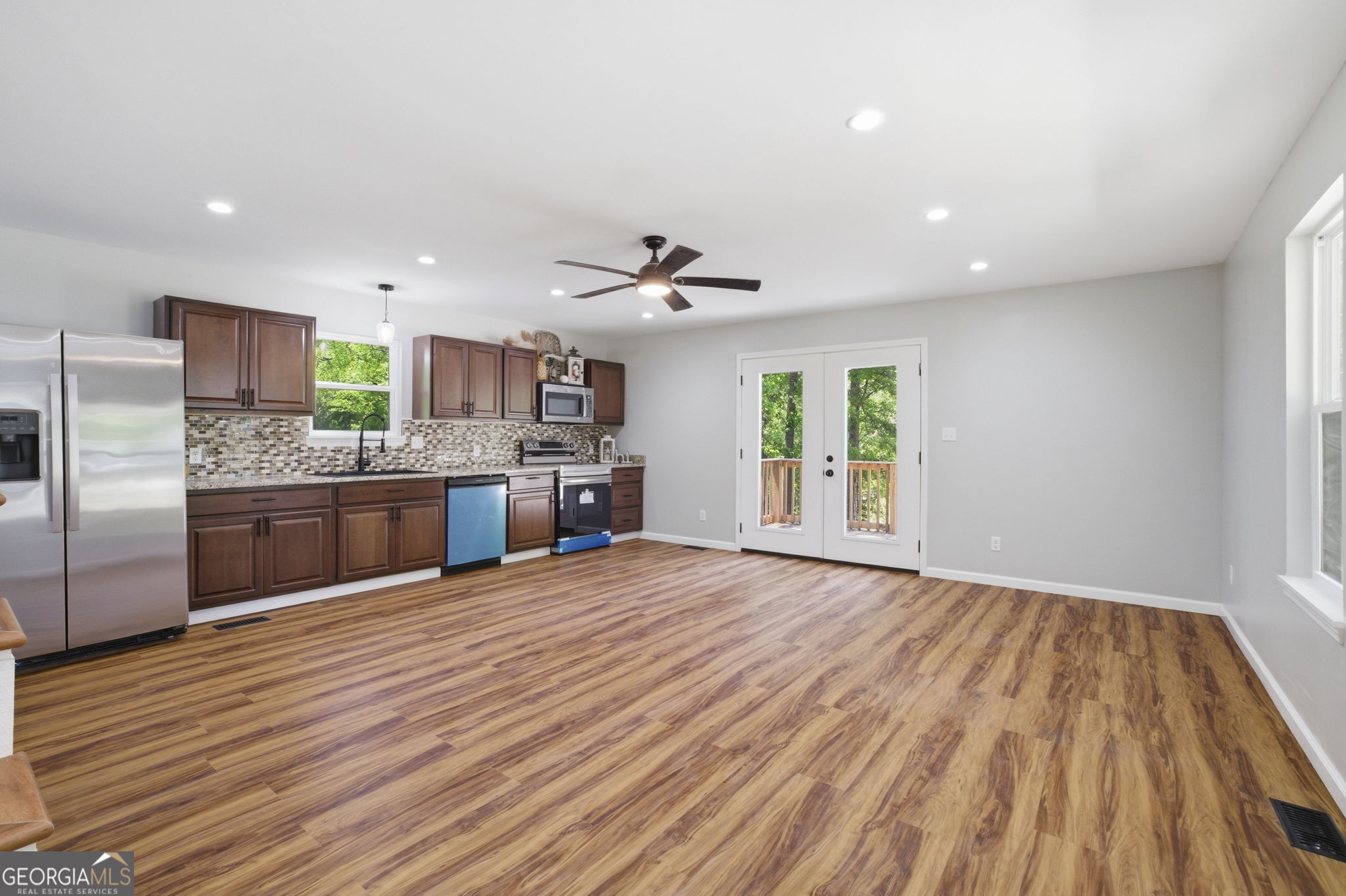 55 Reece Street Menlo, GA 30731 - Photo 3 of 36 a large kitchen with stainless steel appliances a large counter top a sink and a refrigerator