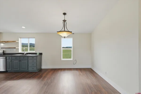 a view of a kitchen with a sink wooden floor and a window