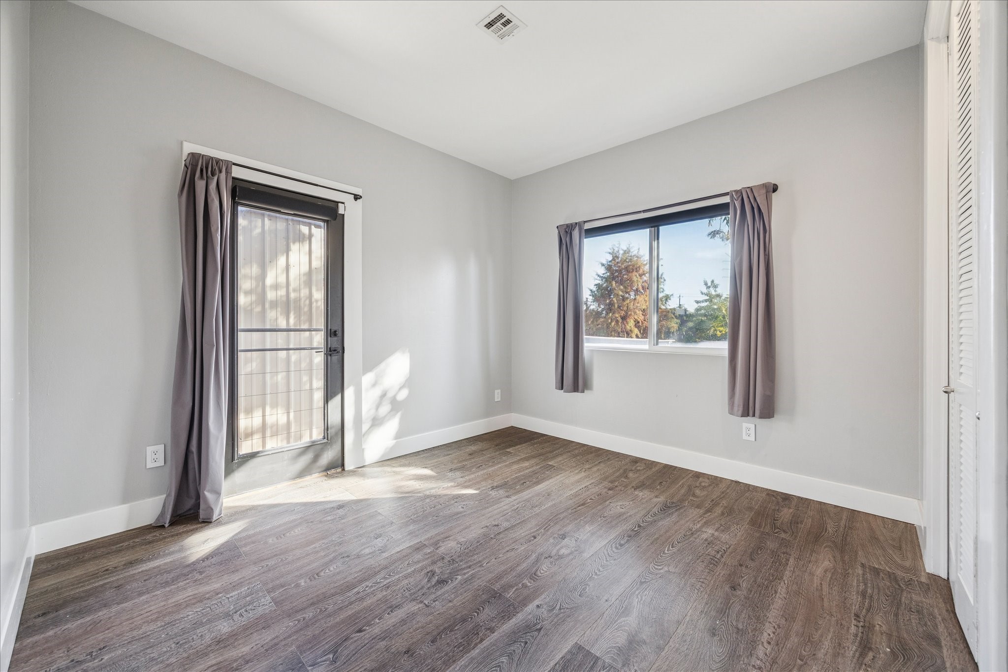 1919 Missouri Street Houston, TX 77019 - Photo 17 of 27 an empty room with wooden floor and windows