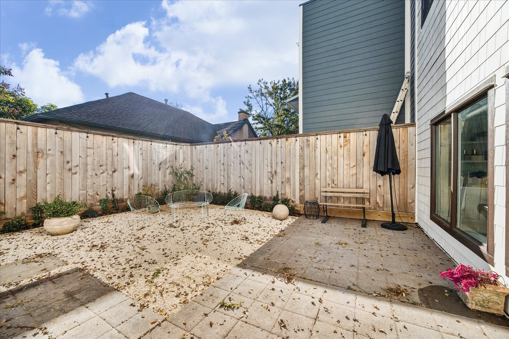 1919 Missouri Street Houston, TX 77019 - Photo 26 of 27 a backyard of a house with barbeque oven table and chairs